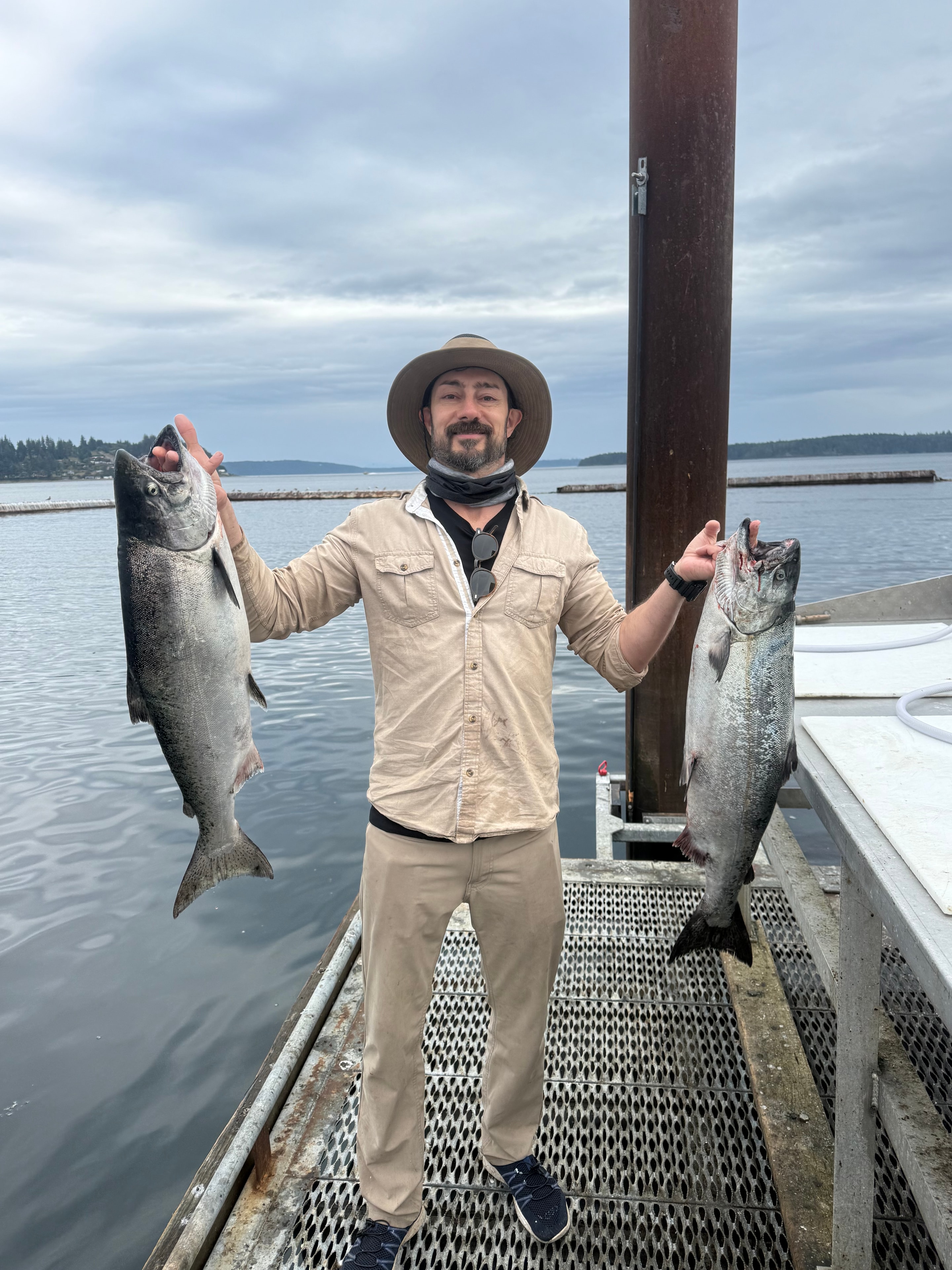 Angler holding large Pacific halibut on dock
