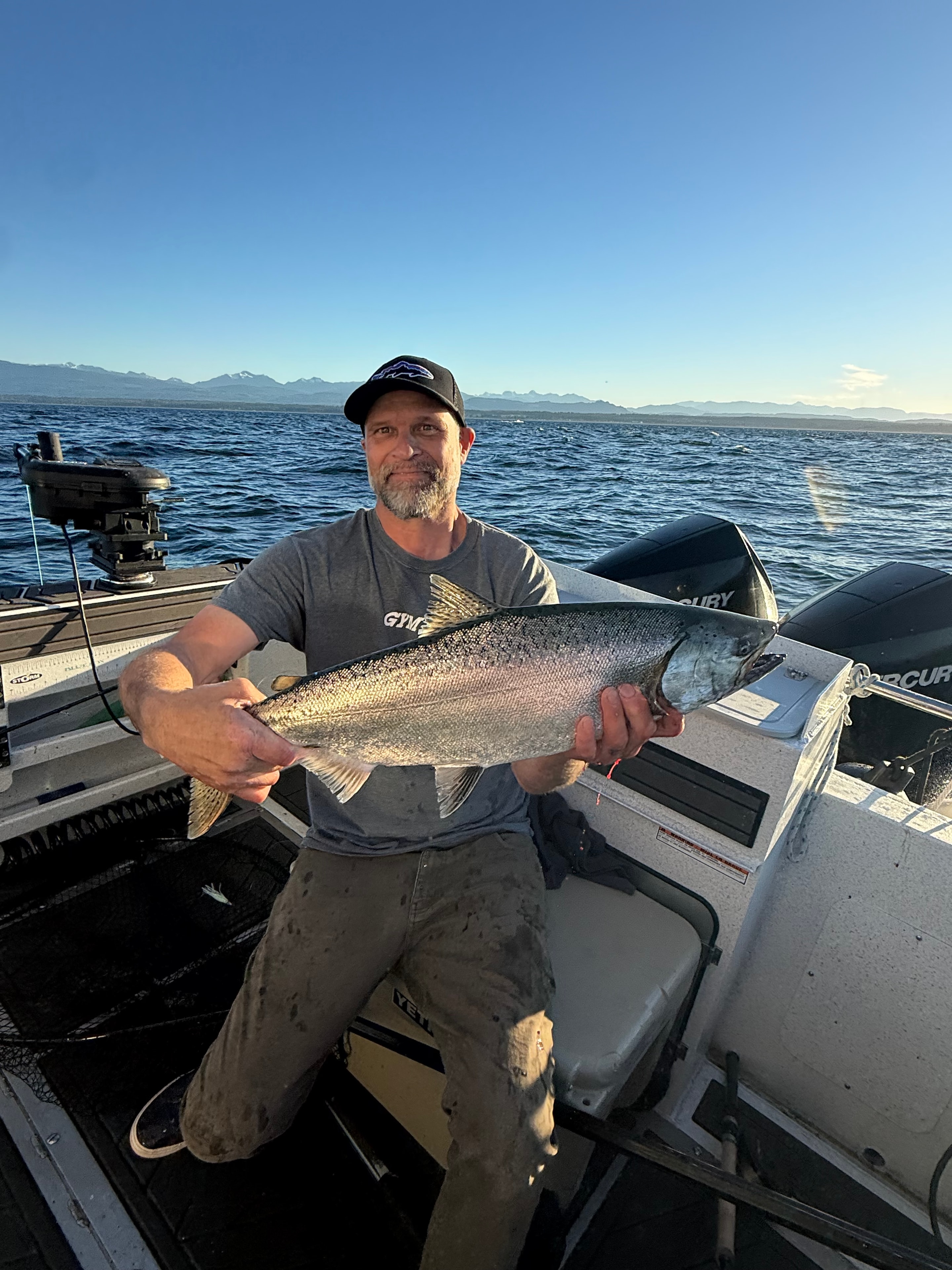 Angler holding salmon on a sunny day
